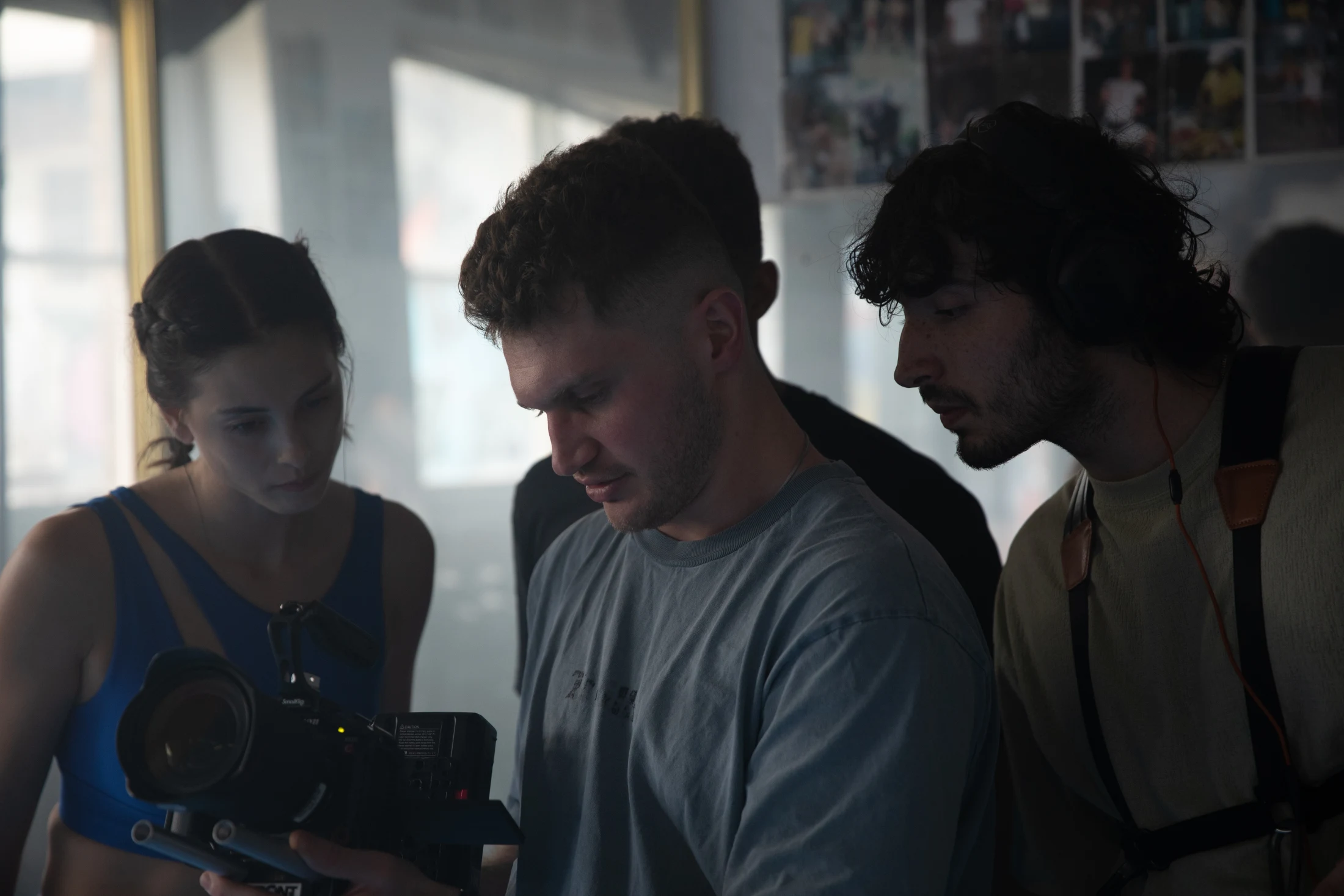 Darian reviewing footage with the crew behind the scenes